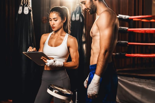 Muay Thai boxer step on weight scale for boxing class designation by weight measurement before boxing fight match. Dedicated athlete fitness and physical boxer's body readiness. Impetus