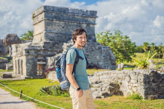 Male tourist enjoying the view Pre-Columbian Mayan walled city of Tulum, Quintana Roo, Mexico, North America, Tulum, Mexico. El Castillo - castle the Mayan city of Tulum main temple.