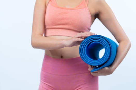 Young attractive asian woman portrait in sportswear with exercising mat. Healthy exercise and workout routine lifestyle concept. Studio shot isolated background. Vigorous