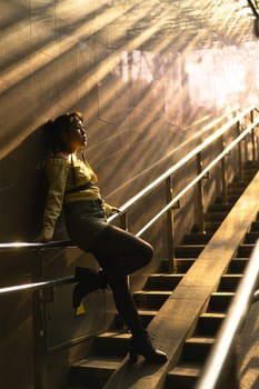 Portrait of a young Asian woman posing in the subway near the stairs