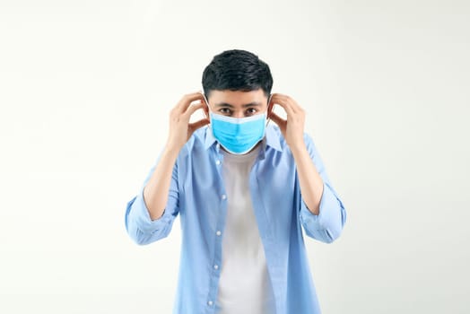 Looks like Asian man wearing a medical mask on white isolated background