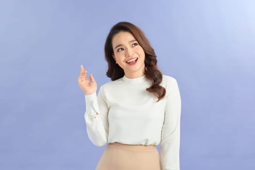 Portrait of happy young Asian woman wearing casual clothes over blue background