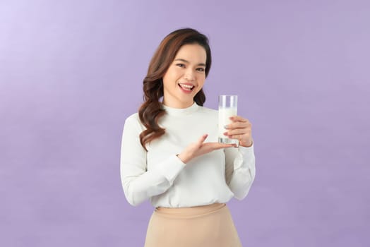 Asian woman holding a glass of milk