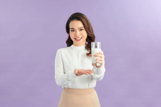 Laughing young woman with a glass of milk