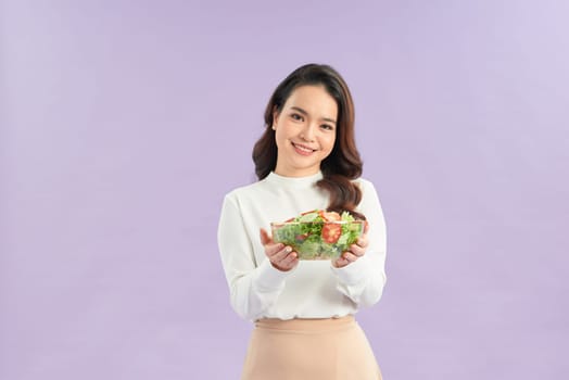 Beautiful young asian eating salad with big smile happy beaming face 