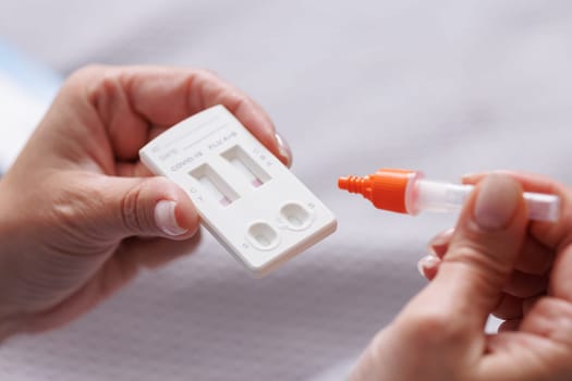 woman tests herself for new coronavirus strain at home, test for detection of covid-19 antigens and flu viruses, diagnosis of disease
