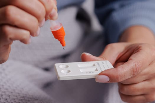woman tests herself for new coronavirus strain at home, test for detection of covid-19 antigens and flu viruses, diagnosis of disease