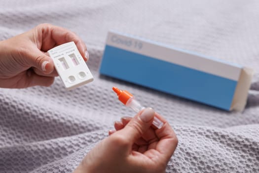 woman tests herself for new coronavirus strain at home, test for detection of covid-19 antigens and flu viruses, diagnosis of disease