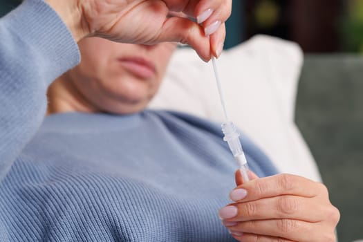 woman tests herself for new coronavirus strain at home, test for detection of covid-19 antigens and flu viruses, diagnosis of disease
