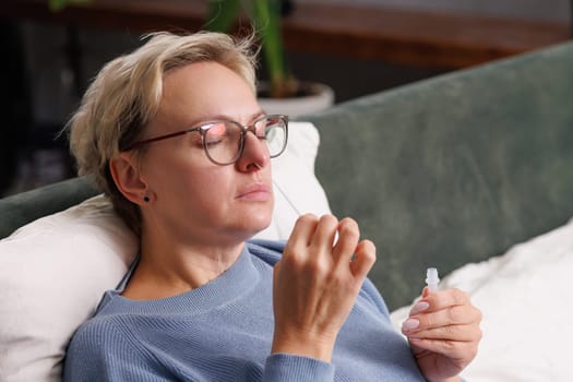 woman tests herself for new coronavirus strain at home, test for detection of covid-19 antigens and flu viruses, diagnosis of disease