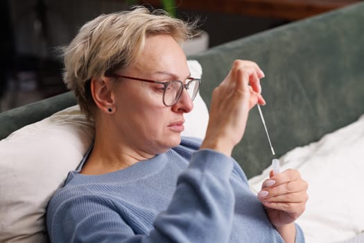 woman tests herself for new coronavirus strain at home, test for detection of covid-19 antigens and flu viruses, diagnosis of disease