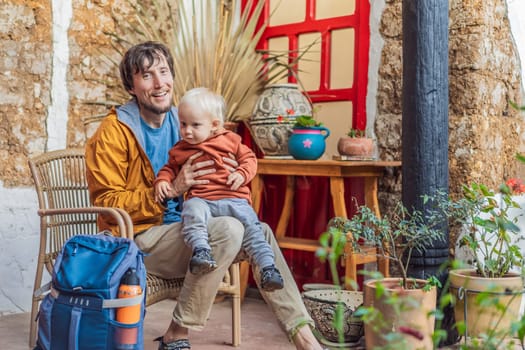 Father and his son tourists in a colonial house in San Cristobal de las Casas, Mexico. Cultural exploration, architecture, and travel experience concept.