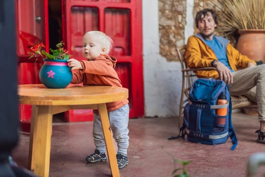 Father and his son tourists in a colonial house in San Cristobal de las Casas, Mexico. Cultural exploration, architecture, and travel experience concept.