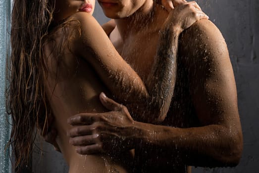 Shirtless man and girl topless embracing in shower view