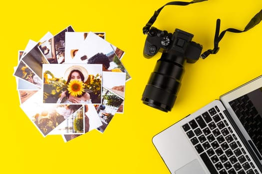 Photo camera with colorful printer photos on yellow background, top view