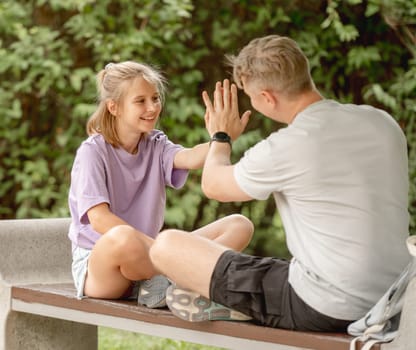 Father And Daughter Playing In The Park On A Summer Day