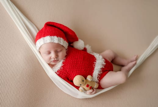 Newborn baby boy wearing Santa Christmas costume. Little infant child New Year xmas portrait