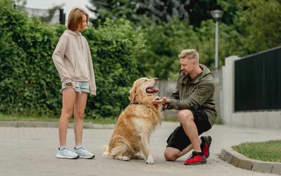 Golden Retriever Gives Paw To Owner Who, With Daughter, Went For A Summer Walk