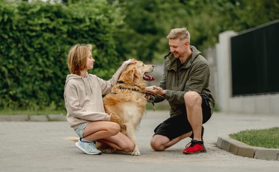 Golden Retriever Gives Paw To Owner Who, With Daughter, Went For A Summer Walk