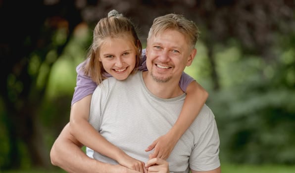 Father And Daughter Posing In A Park During Summer