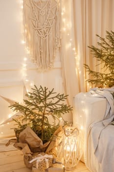 Designer Christmas tree decoration with light decorations. The concept of celebrating New Year and Christmas. Gifts in craft packaging under the Christmas tree.