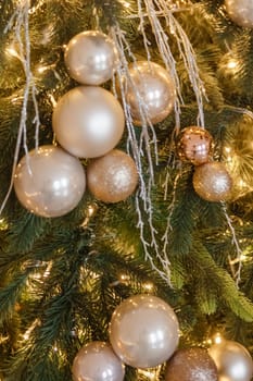 Christmas balls in close-up on the Christmas tree. Decorations for Christmas trees. The concept of celebrating New Year and Christmas