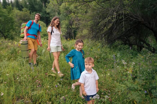 A joyful family joyfully exploring the lush greenery during a memorable hike through beautiful nature