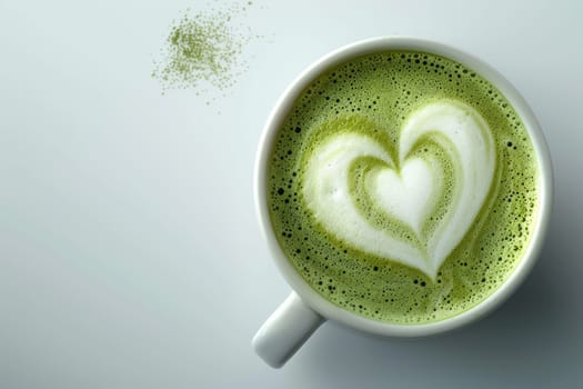 Matcha latte coffee cup with heart latte art on white background, top view with copy space