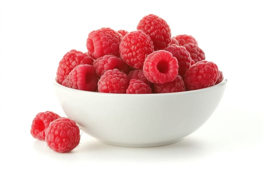 A bowl overflowing with plump, fresh raspberries sits on a light background, highlighting their rich red color and delicate shape, perfect for desserts or snacking.