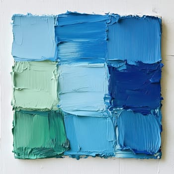 A vibrant arrangement of paint squares in shades of blue and green illustrates an artist\'s creative process, set against a textured white background, conveying a sense of artistic exploration.
