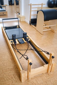 the reformer machine in the pilates room. Yoga equipment.