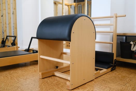 Pilates simulator is a barrel in the yoga room. Pilates equipment.
