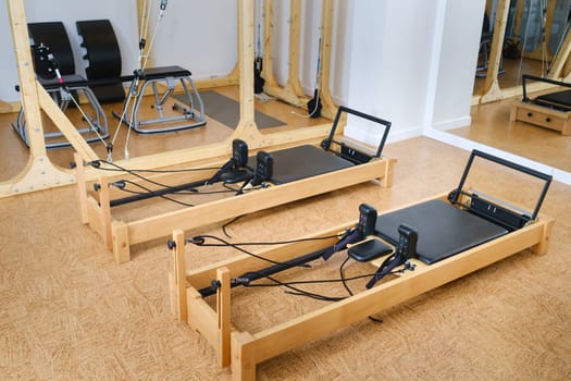 the reformer machine in the pilates room. Yoga equipment.