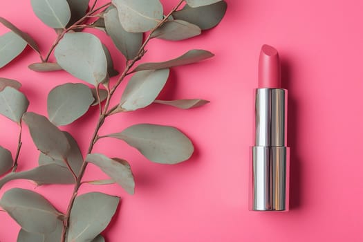 This vibrant composition features a pink lipstick tube elegantly placed beside eucalyptus leaves, all set against a bright pink background, creating a stylish visual impact.