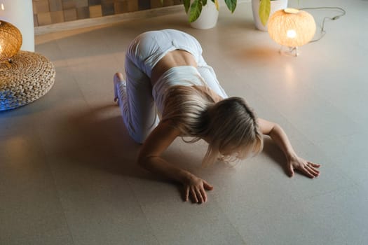 Girl doing meditating bodywork at the gym . Girl doing yoga in the gym.