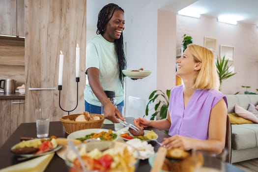 Friends enjoy a delightful meal together in a warm, inviting setting.