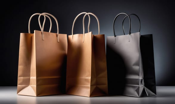 Three paper shopping bags are arranged in a row on a dark background. The bags are brown, light brown, and black. The bags are empty and appear to be unused.