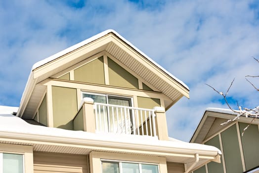 Top of residential house on blue sky background on winter season in Canada.