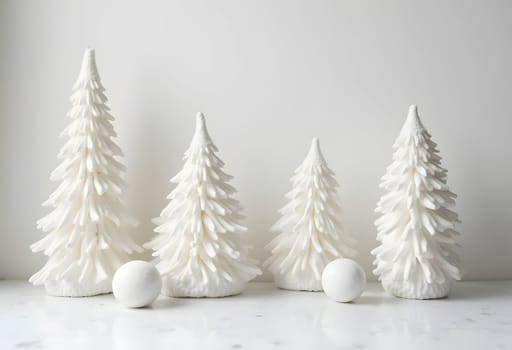 White decorative spruce trees in Scandinavian minimalism style on a white background. High quality photo