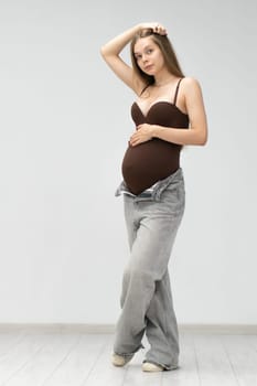 pregnancy positive happy motherhood expectant jeans tummy female mother background maternity girl