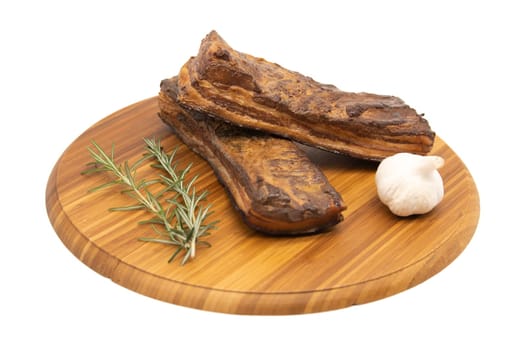 Delicious artisanal whole smoked slab bacon on a cutting block.
