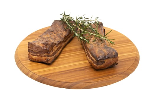 Delicious artisanal whole smoked slab bacon on a cutting block.