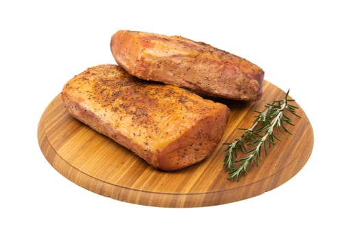 Smoked ham on a rustic wooden board with fresh rosemary. Natural product from an organic farm, produced using traditional methods.