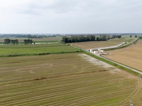 Overhead Aerial view of a flooded fields showcasing the impact of unusual heavy rainfall on rural landscapes during autumn