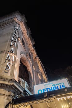 London, UK Nighttime view of Wyndhams theater entrance with large sign advertising "Oedipus", starring Mark Strong.