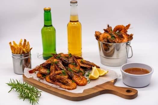 Indulge in a tempting seafood platter that features succulent shrimp, crispy fries, and refreshing cold beverages