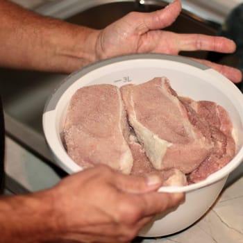 In a white bowl, large, even pieces of meat. Pieces of pork meat are prepared for cooking dinner. High quality photo