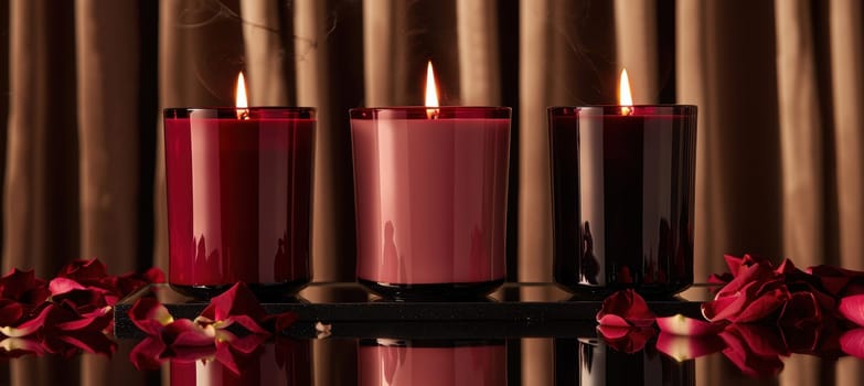 Elegant valentine's day candle set features three red and pink scented candles in a minimalist design, set on a mirrored surface adorned with delicate rose petals, perfect for creating a romantic ambiance at home.