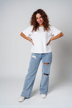 Young woman posing confidently in casual attire against a neutral backdrop close up