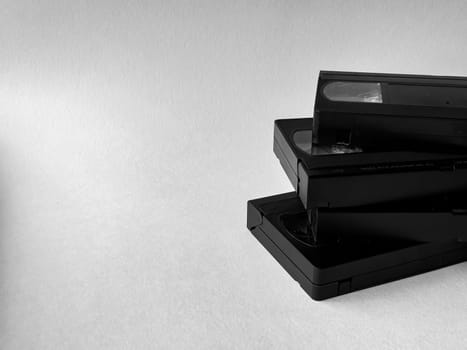 Stack of vintage vhs tapes on minimalist white background.